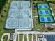 Aerial view of well-maintained community tennis courts with lush landscaping and convenient parking at 1407 Palmer Hill Dr, Durham, NC 27703