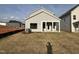 View of the home's rear exterior, featuring a covered patio and a spacious lawn at 1511 Malcus Ct # 64, Fuquay Varina, NC 27526
