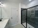 Bright bathroom with a glass-enclosed shower featuring sleek, modern tiling and contemporary fixtures at 1511 Malcus Ct # 64, Fuquay Varina, NC 27526