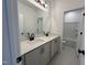 Bright bathroom featuring double vanities, large mirror, and modern fixtures with easy access to tub and toilet at 1511 Malcus Ct # 64, Fuquay Varina, NC 27526