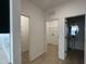 Hallway showing doorways to a laundry room, a walk-in closet and a powder room at 1511 Malcus Ct # 64, Fuquay Varina, NC 27526
