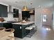 Kitchen with an island, counter seating, stainless steel appliances, and dark cabinets at 1511 Malcus Ct # 64, Fuquay Varina, NC 27526