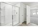 Modern bathroom showcasing a frameless glass shower and an open doorway to the bedroom at 153 Klamath Dr, Garner, NC 27529