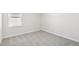 Small bedroom featuring plush carpeting, white walls, white trim and a single window at 153 Klamath Dr, Garner, NC 27529