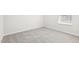 This bedroom features neutral carpeting, a window with white blinds, and white trim at 153 Klamath Dr, Garner, NC 27529