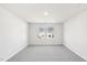 Bright bedroom featuring neutral gray walls, plush carpeting, and a double window at 153 Klamath Dr, Garner, NC 27529