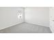 Cozy bedroom featuring neutral gray walls, plush carpeting and a single window at 153 Klamath Dr, Garner, NC 27529