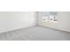 Well-lit bedroom featuring plush carpeting, white walls and a view of the backyard at 153 Klamath Dr, Garner, NC 27529