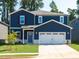 Charming two-story home featuring a spacious two-car garage and beautifully landscaped front yard at 153 Klamath Dr, Garner, NC 27529