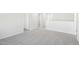 Spacious hallway with neutral gray walls, plush carpeting, and white trim throughout at 153 Klamath Dr, Garner, NC 27529
