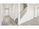 Well-lit hallway featuring a carpeted staircase, modern floors, and a neutral color palette at 153 Klamath Dr, Garner, NC 27529