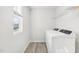 This bright laundry room features a front-load washing machine, a window and wire shelving at 153 Klamath Dr, Garner, NC 27529