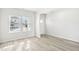 Open-concept living space with pristine white walls, two windows, and light-colored floors at 153 Klamath Dr, Garner, NC 27529