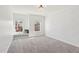 Cozy bedroom featuring soft carpet, two windows with neighborhood views, and a charming window seat at 1532 Champlain Crest Way, Cary, NC 27513