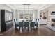 Well-lit dining room with dark wood floors, built-in shelves, and ample seating at 1532 Champlain Crest Way, Cary, NC 27513