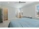 Spacious bedroom featuring a ceiling fan, natural lighting, ensuite bathroom, and a walk-in closet at 169 Black Cloud Dr, Louisburg, NC 27549
