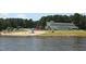 Beautiful waterfront community building offering a beach and easy access for swimming and other water activities at 169 Black Cloud Dr, Louisburg, NC 27549