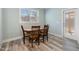 Cozy dining room features natural light and a wooden table with four chairs at 169 Black Cloud Dr, Louisburg, NC 27549