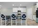 Kitchen features white cabinets, granite counters, stainless steel appliances, and bar stool seating at 169 Black Cloud Dr, Louisburg, NC 27549