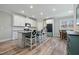 Bright kitchen with white cabinets, granite counters, stainless steel appliances, and a central island at 169 Black Cloud Dr, Louisburg, NC 27549