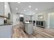 Bright kitchen featuring white cabinets, a central island, stainless steel appliances, and hardwood floors at 169 Black Cloud Dr, Louisburg, NC 27549