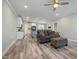 Open concept living room that flows into a modern kitchen with light-gray walls and hardwood floors at 169 Black Cloud Dr, Louisburg, NC 27549
