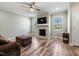 Bright living room with a fireplace, hardwood floors, and large windows at 169 Black Cloud Dr, Louisburg, NC 27549