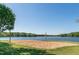 Sandy volleyball court by the lake for outdoor recreation and enjoyment at 169 Black Cloud Dr, Louisburg, NC 27549