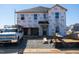 New home under construction featuring Tyvek home wrap, windows, and a truck in the driveway at 18 Thistle Patch Pl, Angier, NC 27501