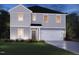 Charming two-story home featuring gray siding, a front-entry two-car garage, and a well-manicured lawn at 18 Thistle Patch Pl, Angier, NC 27501