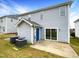Exterior view of a home with blue siding, a patio and two AC units at 2013 Turtle Point Dr, Raleigh, NC 27604