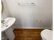 Small bathroom features a sink with pedestal, toilet and modern fixtures at 2013 Turtle Point Dr, Raleigh, NC 27604