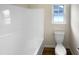 Bathroom features toilet, window and tub/shower combination at 2013 Turtle Point Dr, Raleigh, NC 27604