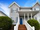 Charming home with a blue front door, brick steps, and mature landscaping at 2013 Turtle Point Dr, Raleigh, NC 27604
