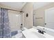 Bathroom with a shower and tub combo, neutral colored walls and brushed bronze fixtures at 21 Tracker Ct, Garner, NC 27529