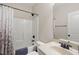 Bathroom with neutral colored walls, shower with patterned shower curtain and black fixtures at 21 Tracker Ct, Garner, NC 27529