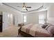 Bright bedroom boasts a tray ceiling, natural light, and access to the bathroom at 21 Tracker Ct, Garner, NC 27529