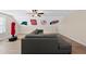 Large bonus room with a gray sectional, wood floors, and sports team logos at 21 Tracker Ct, Garner, NC 27529