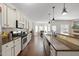 Spacious kitchen boasts stainless steel appliances, granite counters, hardwood floors and a breakfast bar at 21 Tracker Ct, Garner, NC 27529