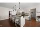 Bright kitchen with barstool seating, stainless steel appliances and ample countertop space at 21 Tracker Ct, Garner, NC 27529