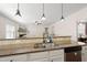 Open kitchen featuring granite countertops, pendant lighting, stainless steel appliances, and bar top seating at 21 Tracker Ct, Garner, NC 27529