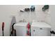 Bright laundry room with a modern washer and dryer, shelf, and storage space at 21 Tracker Ct, Garner, NC 27529