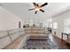 Open concept living room with hardwood floors and comfortable sectional sofa and view to the kitchen at 21 Tracker Ct, Garner, NC 27529