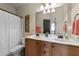 Bright bathroom featuring a double vanity with a pristine white countertop and wooden cabinets at 225 Woodfield Ct, Fuquay Varina, NC 27526