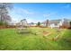 Landscaped backyard with a swing set and garden boxes at 236 Bowling Farm Ct, Raleigh, NC 27603