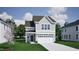 Charming two-story home with gray siding, a two-car garage, and beautifully landscaped front yard at 239 Meadowbark Bnd # 27, Garner, NC 27529