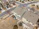 An aerial view shows the house and back yard with patio seating area and surrounding neighborhood at 241 Westgrove Ct, Durham, NC 27703