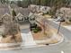 Aerial view of a two-story home with a two-car garage surrounded by mature trees and landscaping at 241 Westgrove Ct, Durham, NC 27703