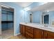 Bathroom with a dual vanity with cherry cabinets, and a walk-in closet at 241 Westgrove Ct, Durham, NC 27703