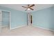 Bedroom featuring a ceiling fan, blue walls, carpet flooring, and two entry doors at 241 Westgrove Ct, Durham, NC 27703